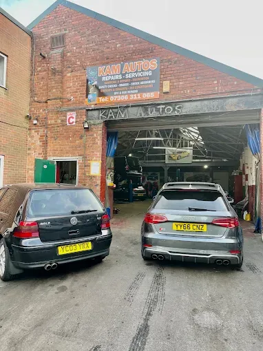 Two cars parked outside the Kam Autos garage in Derby